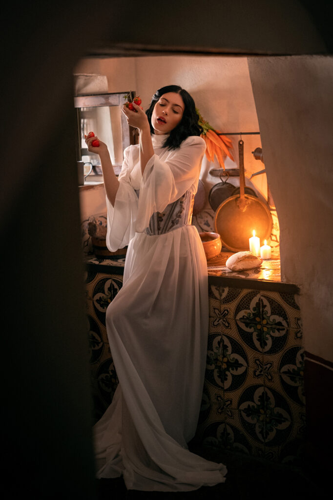 Woman standing in gown enjoying food, fashion retouching, cinematic Italy-inspired editorial
