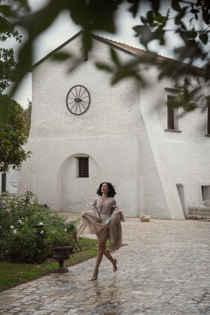 Outdoor scene in front of white Italian villa, moody fashion photography